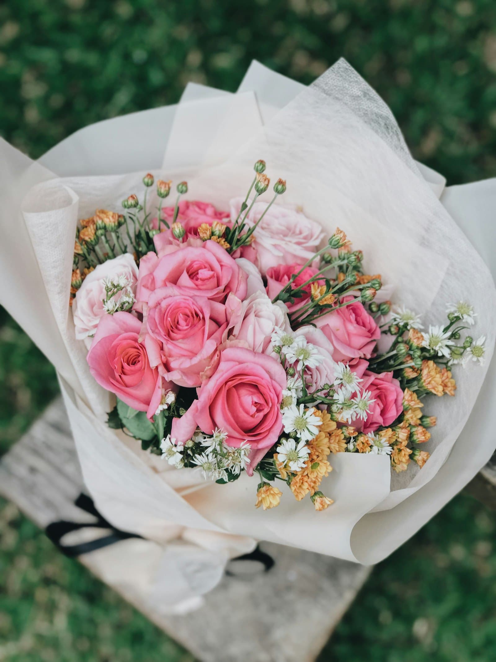 Pink rose bouquet wrapped in white paper